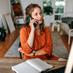 Contractor on the phone negotiating with insurance about restoration invoice line items