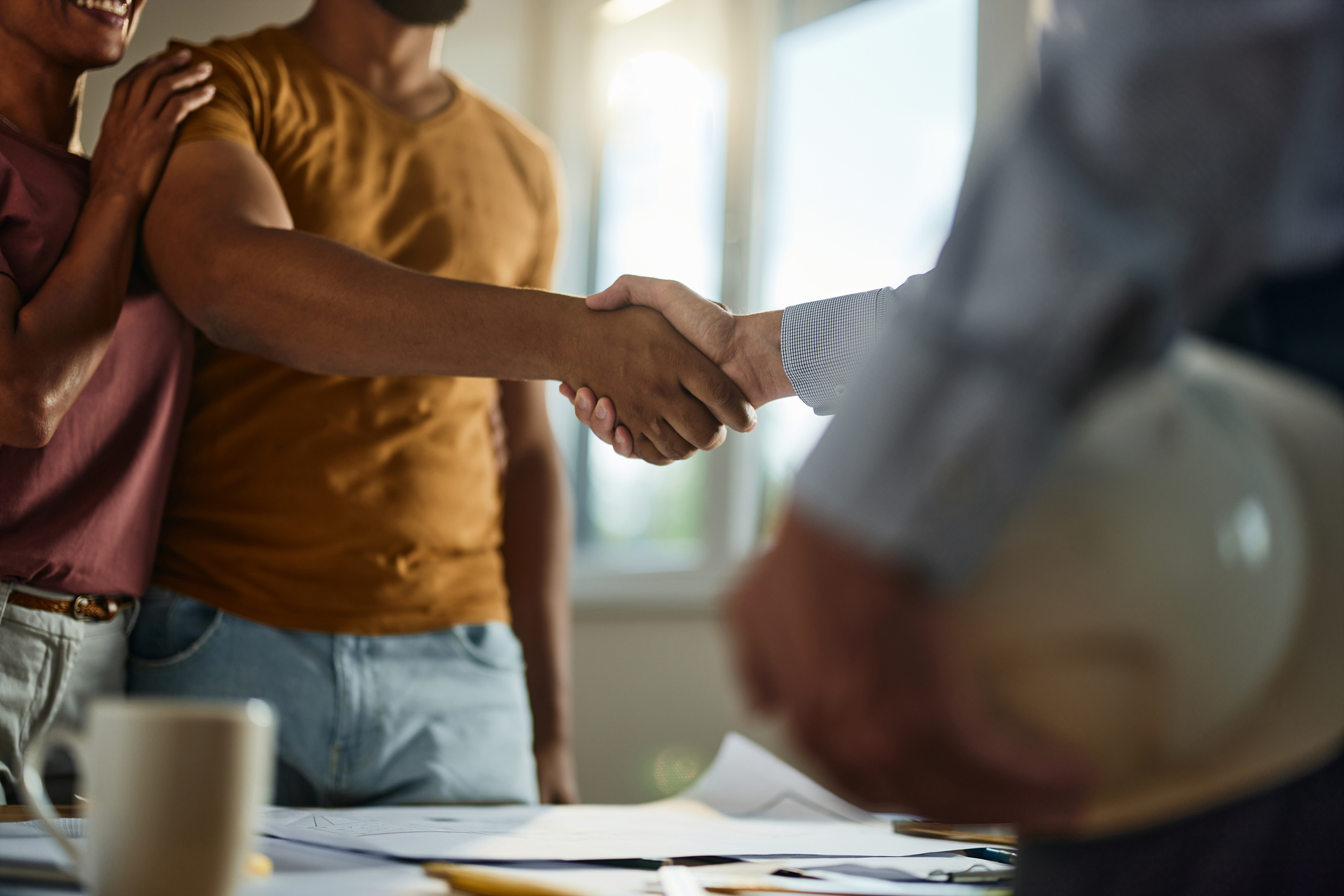 Couple shakes hands with restoration contractor after discussing Direction to Pay