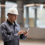 Restoration Contractor Using Xactimate on his phone to create an invoice