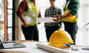 Two restoration contractors discuss legal paperwork with a homeowner.