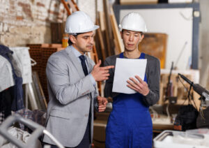 An insurance adjuster and restoration contractor discuss a job.