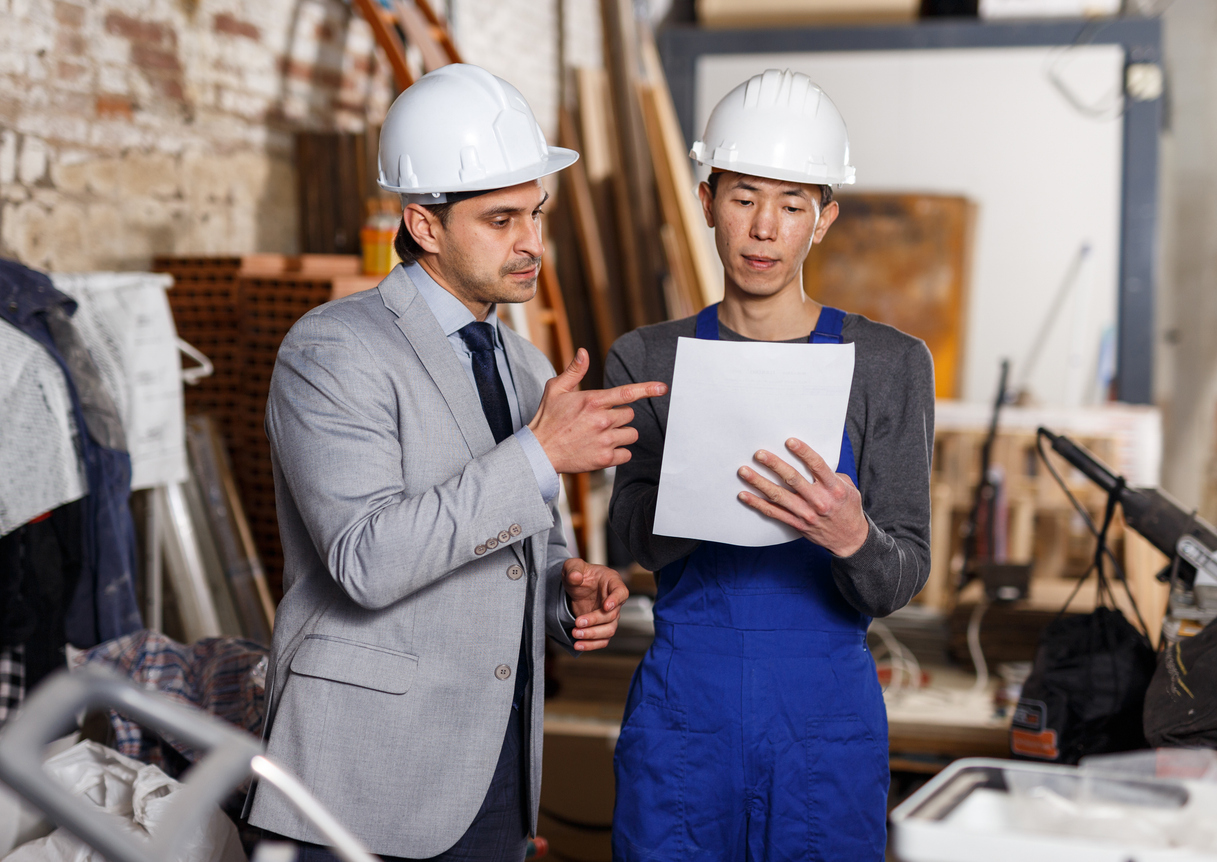 An insurance adjuster and restoration contractor discuss a job.