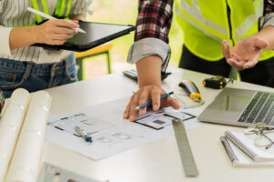 Two restoration contractors discuss floorplans as a part of a restoration project.