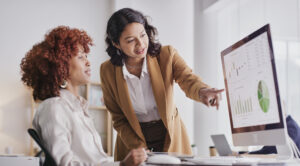Two restoration insurance billing experts view claims data and discuss billing performance.