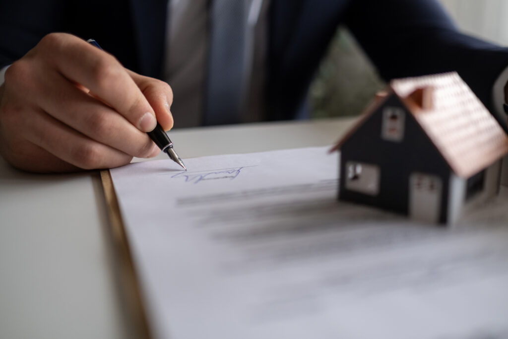 A homeowner signs an Assignment of Benefits agreement with their restoration contractor before water damage restoration services are performed.