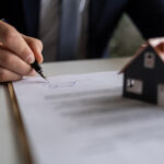 A homeowner signs an Assignment of Benefits agreement with their restoration contractor before water damage restoration services are performed.