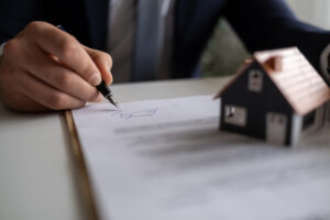 A homeowner signs an Assignment of Benefits agreement with their restoration contractor before water damage restoration services are performed.