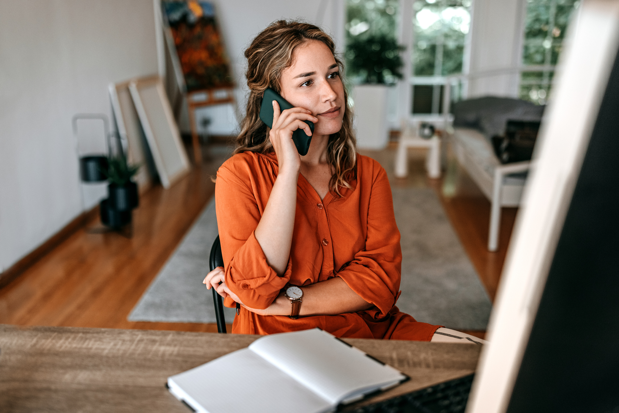 Contractor on the phone negotiating with insurance about restoration invoice line items