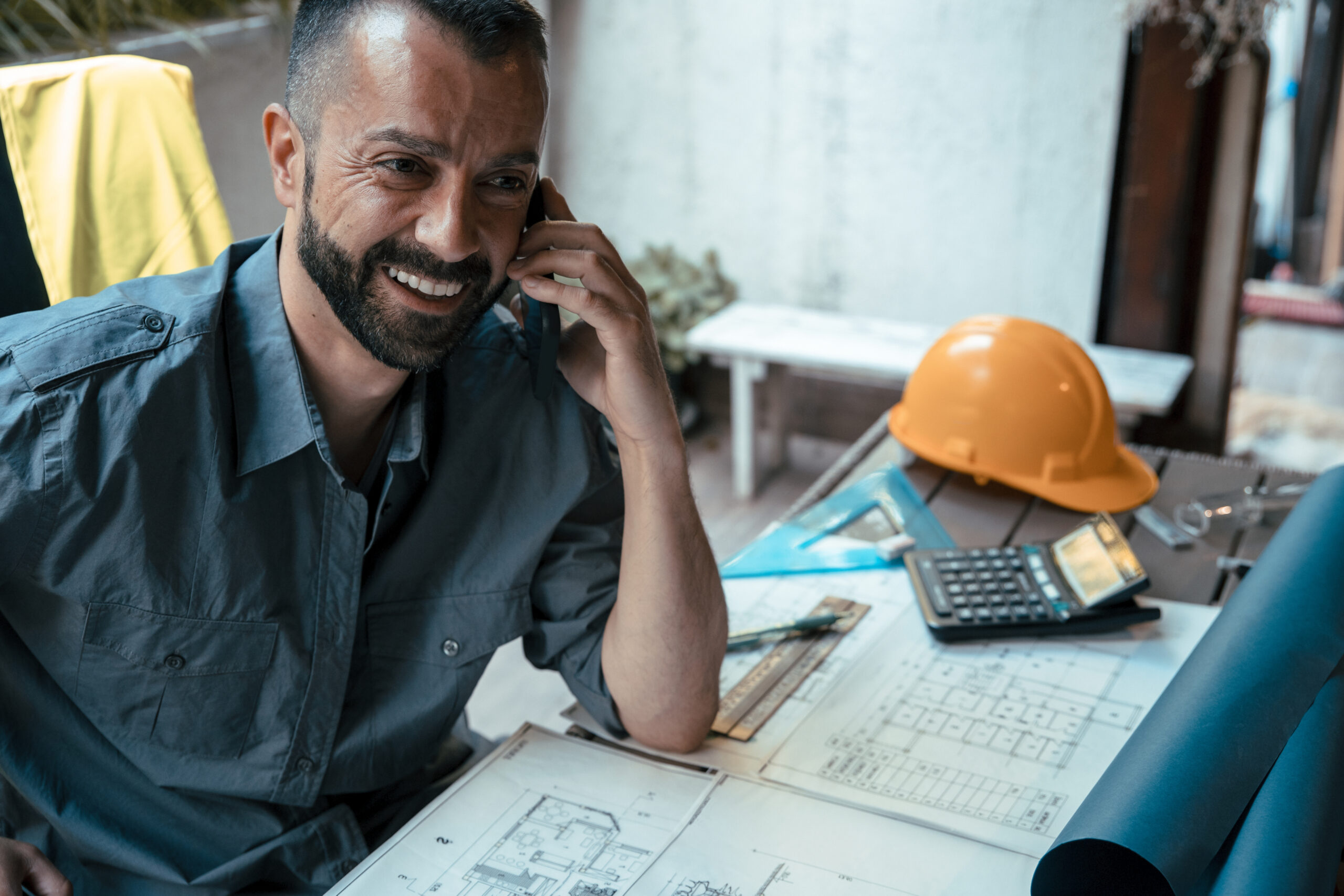 Restoration business owner talking on the phone while analyzing company profit.