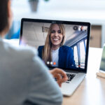 Account manager communicating via video call with their restoration contractor client.