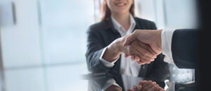 Shaking hands during an interview for a restoration insurance billing team position