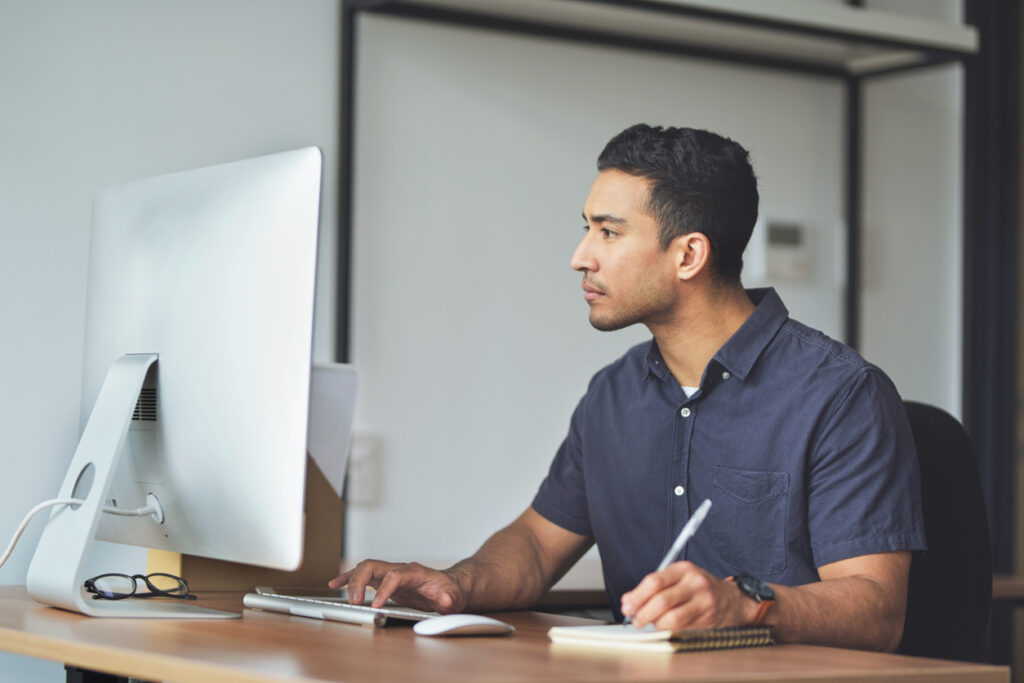 A restoration business owner uses AI tools on his computer while he is handling restoration insurance billing