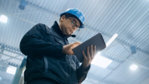 A restoration technician uses restoration claims technology on a tablet while on site.