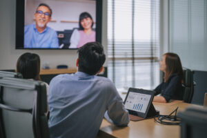 Restoration contractors on a video call about outsourcing restoration insurance billing.