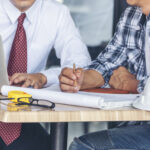 A restoration contractor discusses a restoration insurance appraisal with an appraisal expert