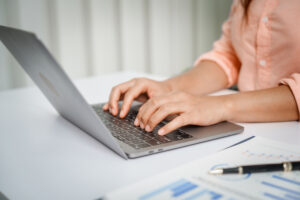 A restoration contractor reviews documentation on a computer for a claim